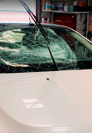 customer car with broken front windshield waiting to be replace by Ram Auto Glass